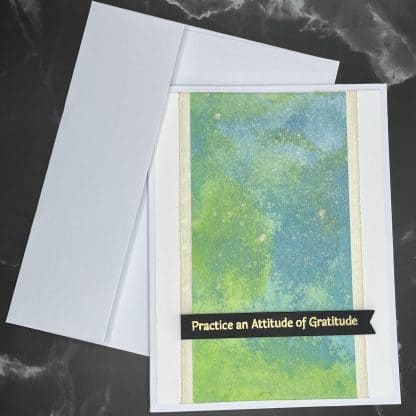 Handmade gratitude card with colorful abstract background and inspiring message.