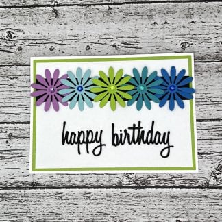 Bright, handcrafted daisy happy birthday greeting card featuring vibrant paper flower embellishments and a cheerful "happy birthday" message.