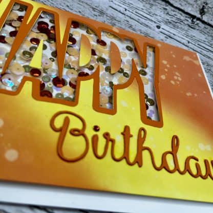 Colorful handmade birthday or recovery card featuring sequins, bright orange and yellow tones, perfect for encouragement and support.