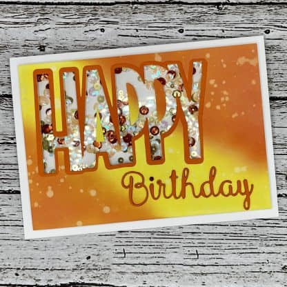 Colorful handmade birthday card with sequins, vibrant orange background, perfect for celebrating special occasions.