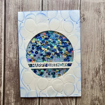 Floating balloons birthday card with blue sequins and "happy birthday" message.