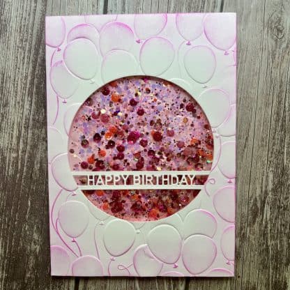 Handmade birthday card with colorful glitter and "happy birthday" message.