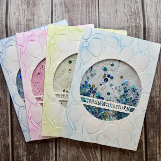 Colorful handmade birthday cards with sequins, glitter, and "Happy Birthday" message.