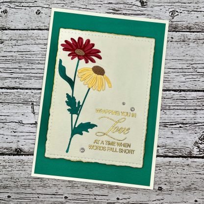 Handmade sympathy card with layered red and yellow flowers, elegant sentiment reading “wrapping you in love at a time when words fall short. ”
