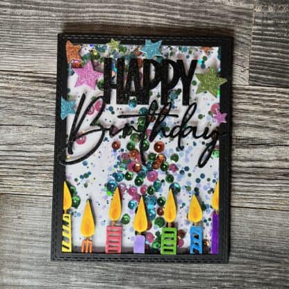 Colorful birthday card with candles, stars, and confetti design.