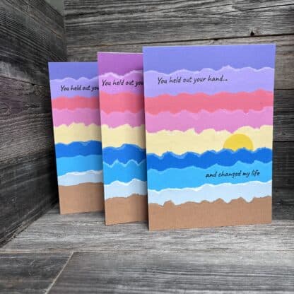 Colorful handmade recovery cards with sunset and uplifting message.