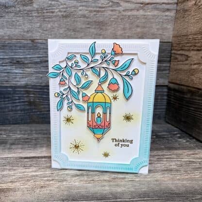 Beautiful handmade card with lantern and floral design, thinking of you message.