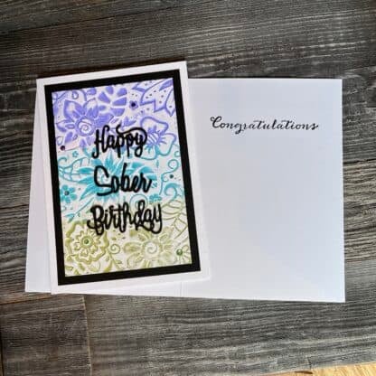 Colorful sober birthday card with floral background and congratulatory message.