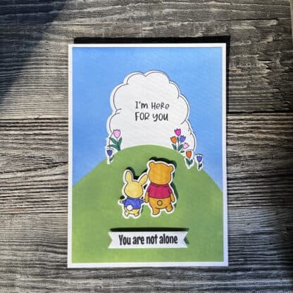 Cute animal recovery card with uplifting message and colorful flowers.